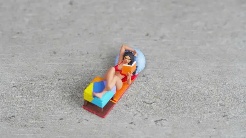 Girl lying down reading a book figurine handpaint high detail 1:18 to HO scale